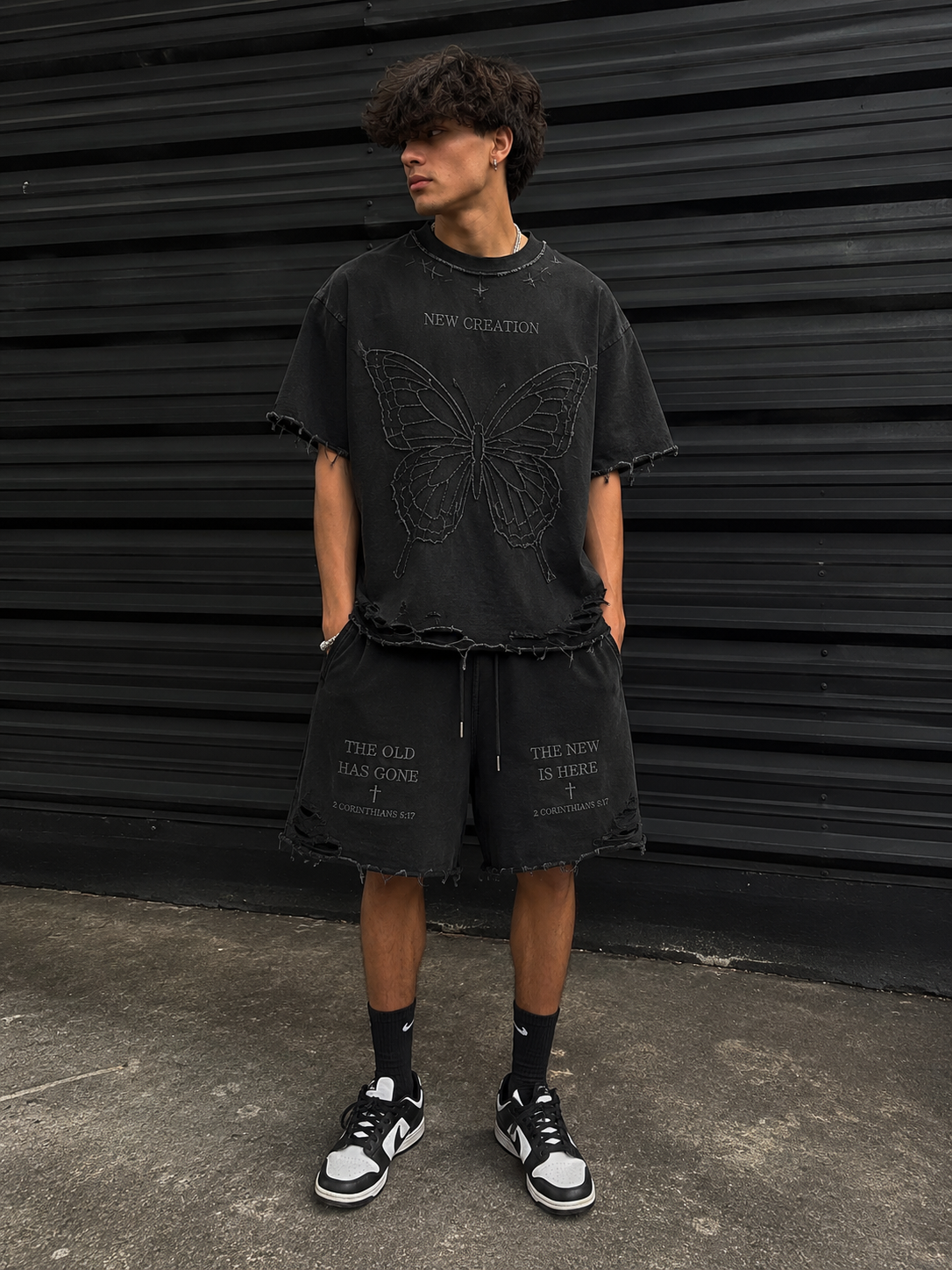 New Creation Tee in washed black with embroidered barbed wire butterfly